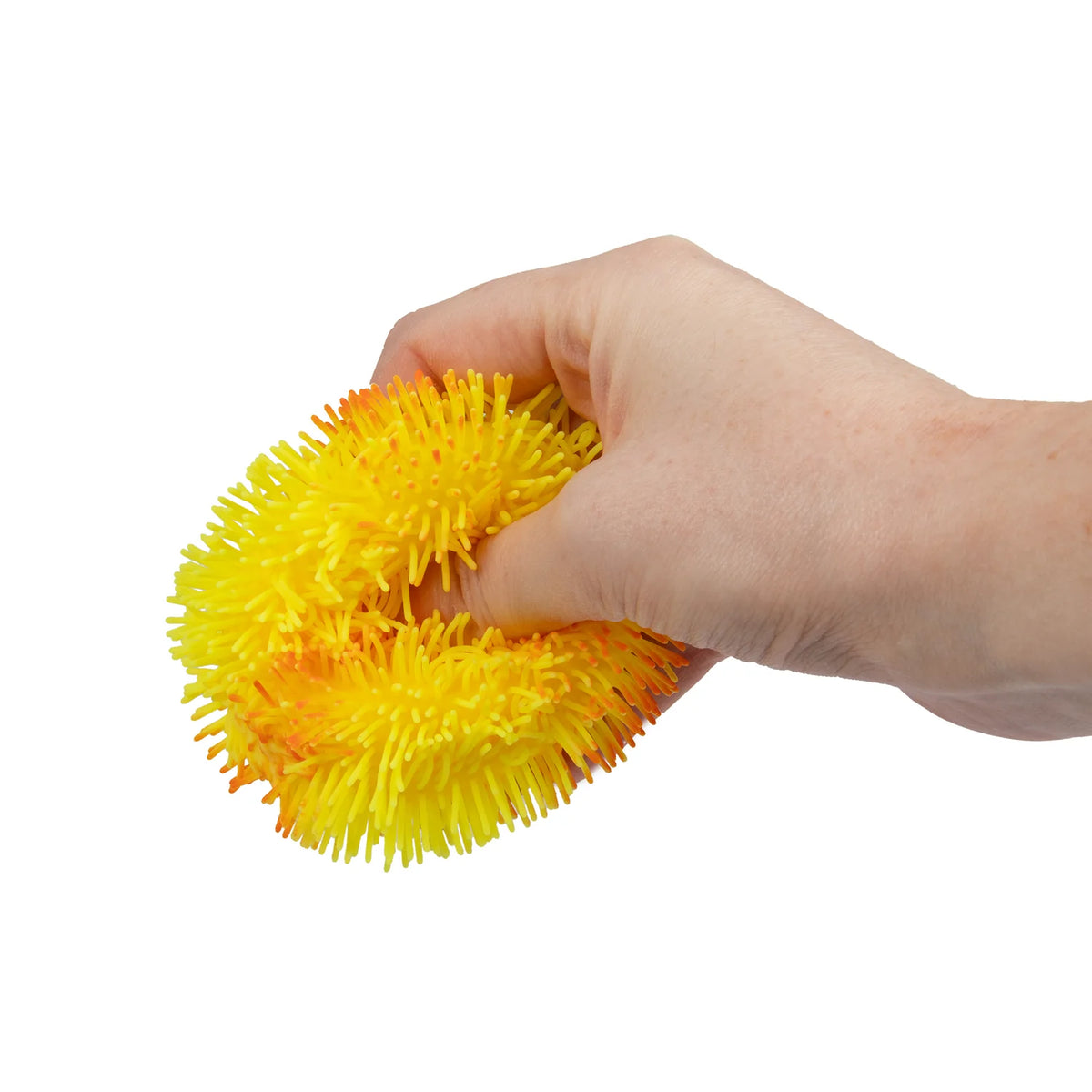 Hand squeezing a yellow Scrunchems Ombre Sensory Sugar Ball puffer toy