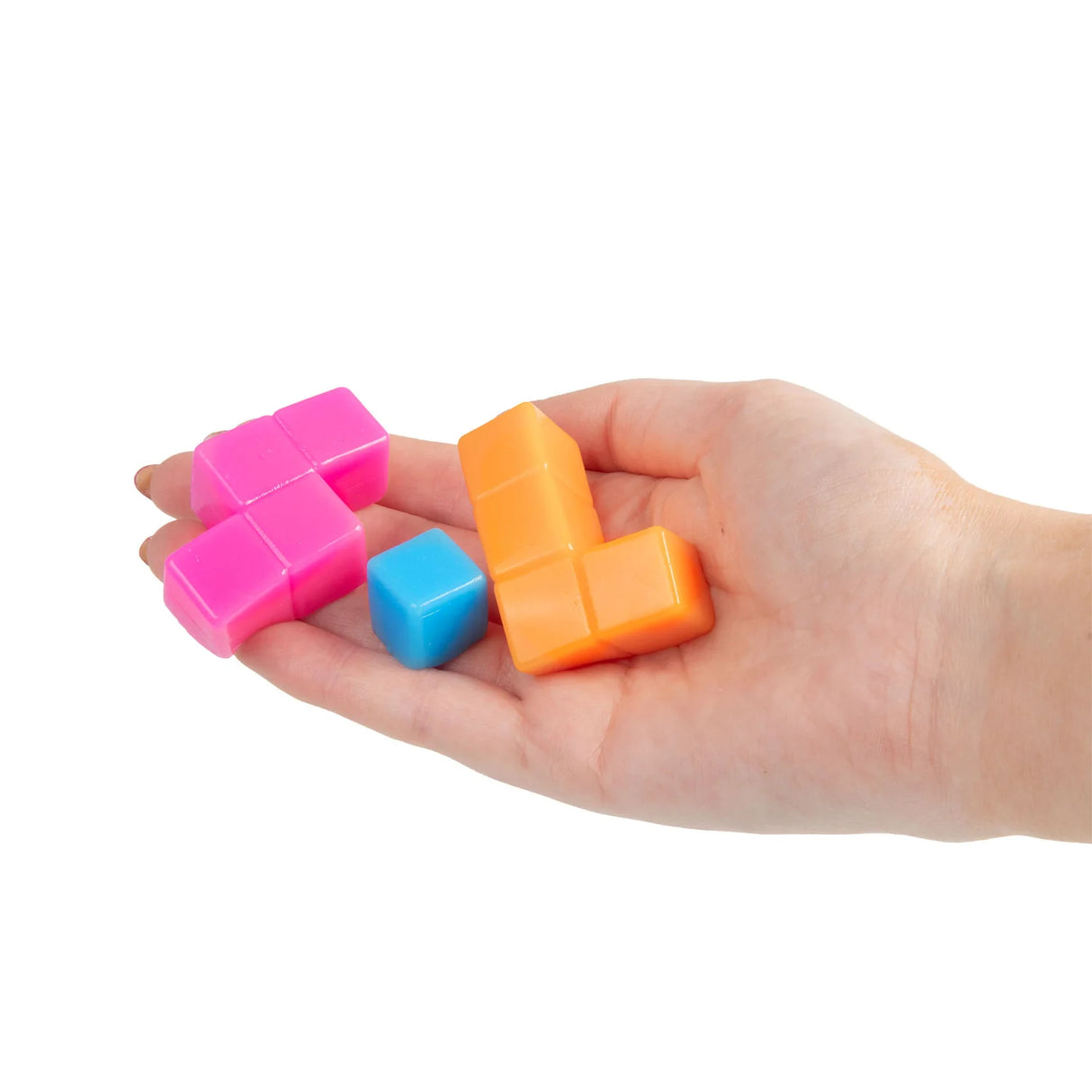 Hand holding pink, blue and orange squishy tetromino puzzle pieces separated and spread across palm