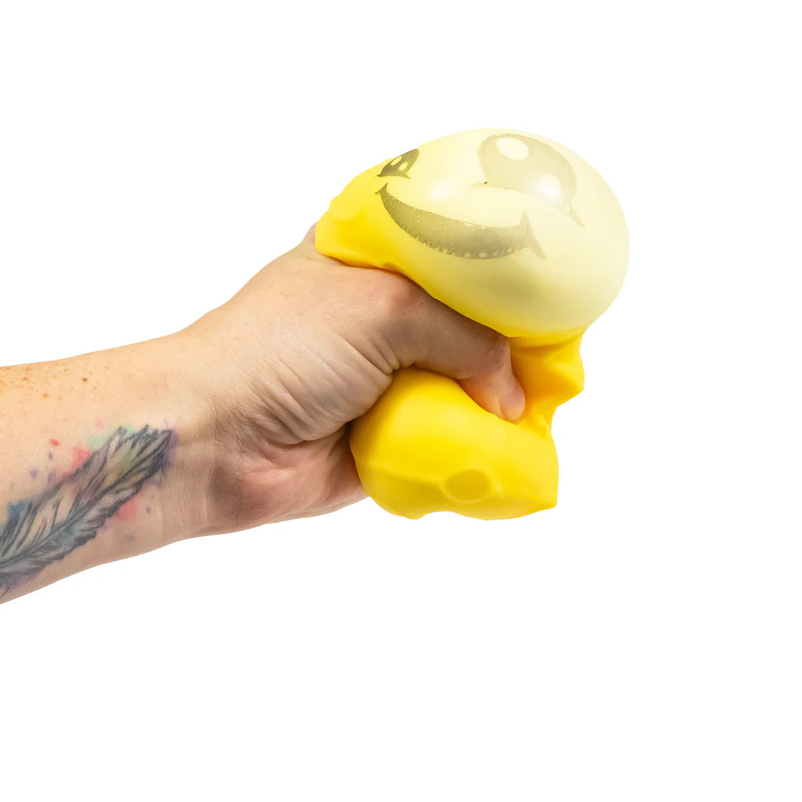 Hand squeezing yellow cheese squishy toy showing inner bubble popping through the top