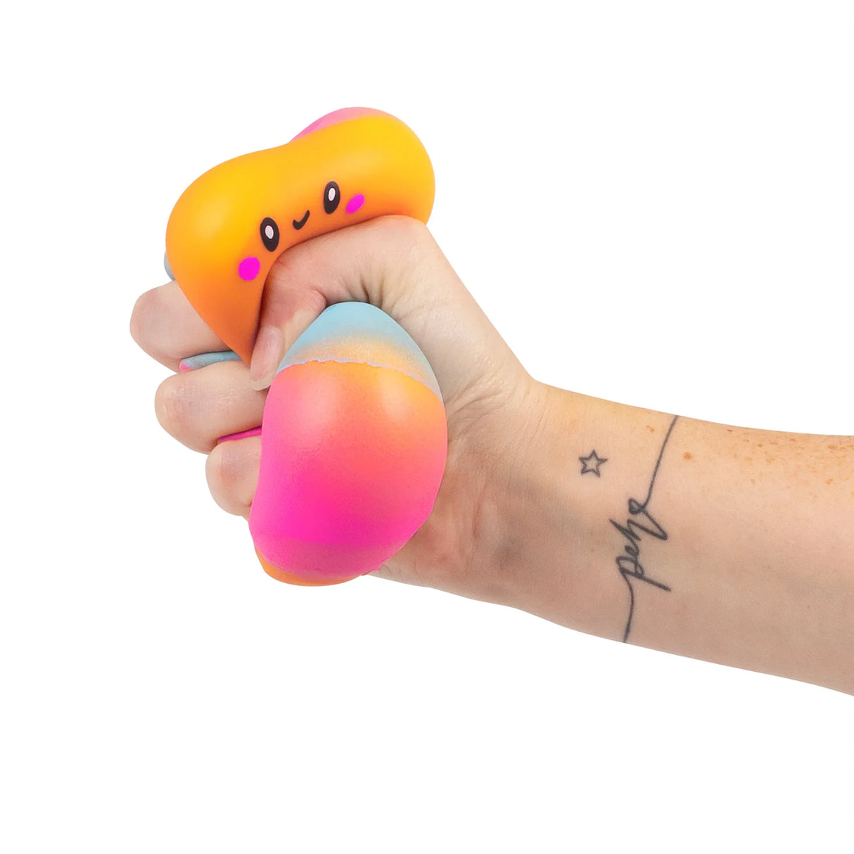 Tattooed hand squeezing a squishy marshmallow toy showing the slow-rise foam deforming