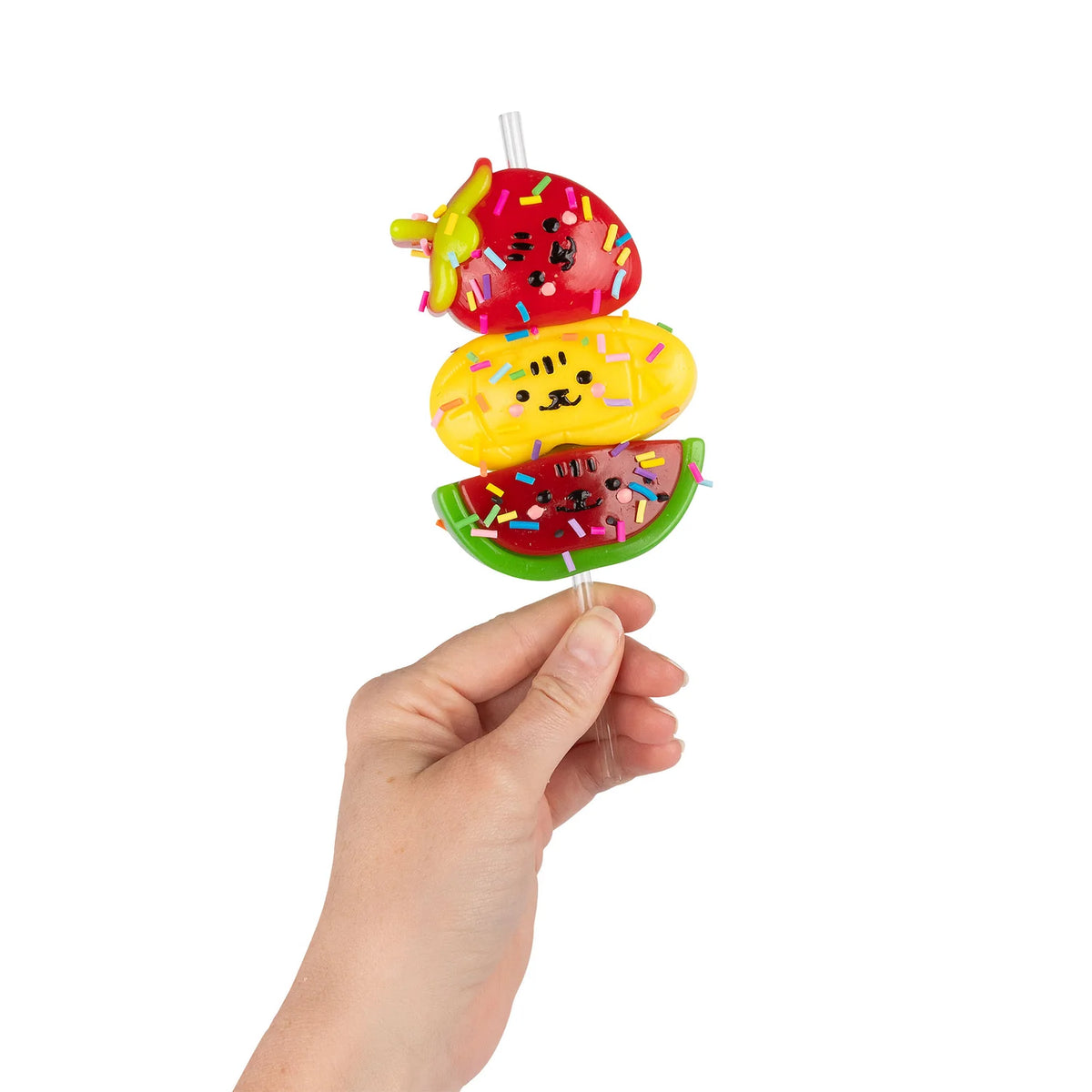 Hand holding Scrunchems Sticky Squishy Fruit Stack of strawberry, mango and watermelon with sprinkles