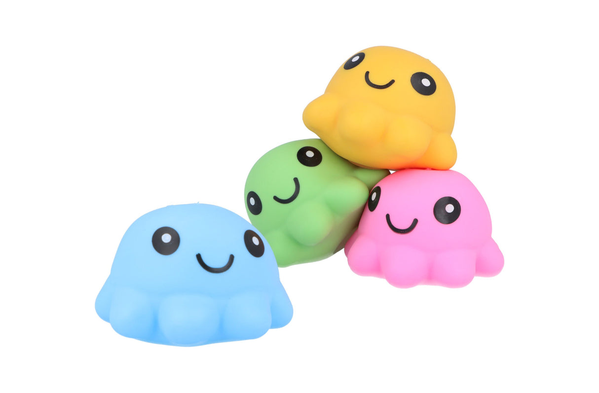 Four kawaii-style squishy octopus squeeze toys in blue, green, pink, and yellow, with three stacked on top of each other and one placed in front, against a white background