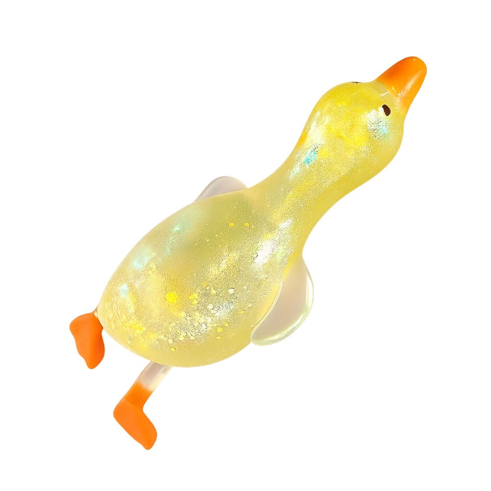 Hand squeezing a translucent yellow glitter squishy duck, showing the glitter shifting inside