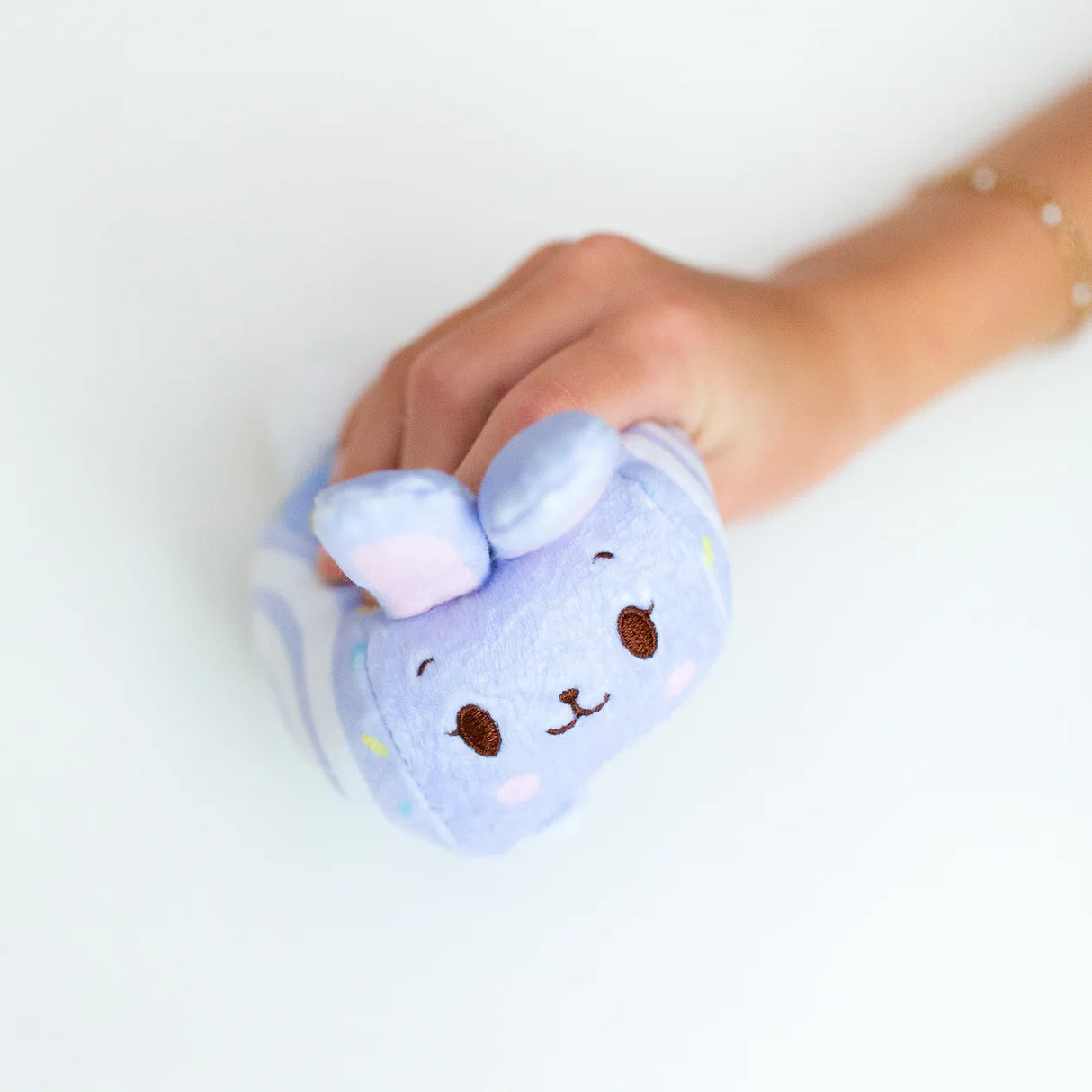 Squish Berries Lavender Pop Bunny purple squishy plush squeezed in hand