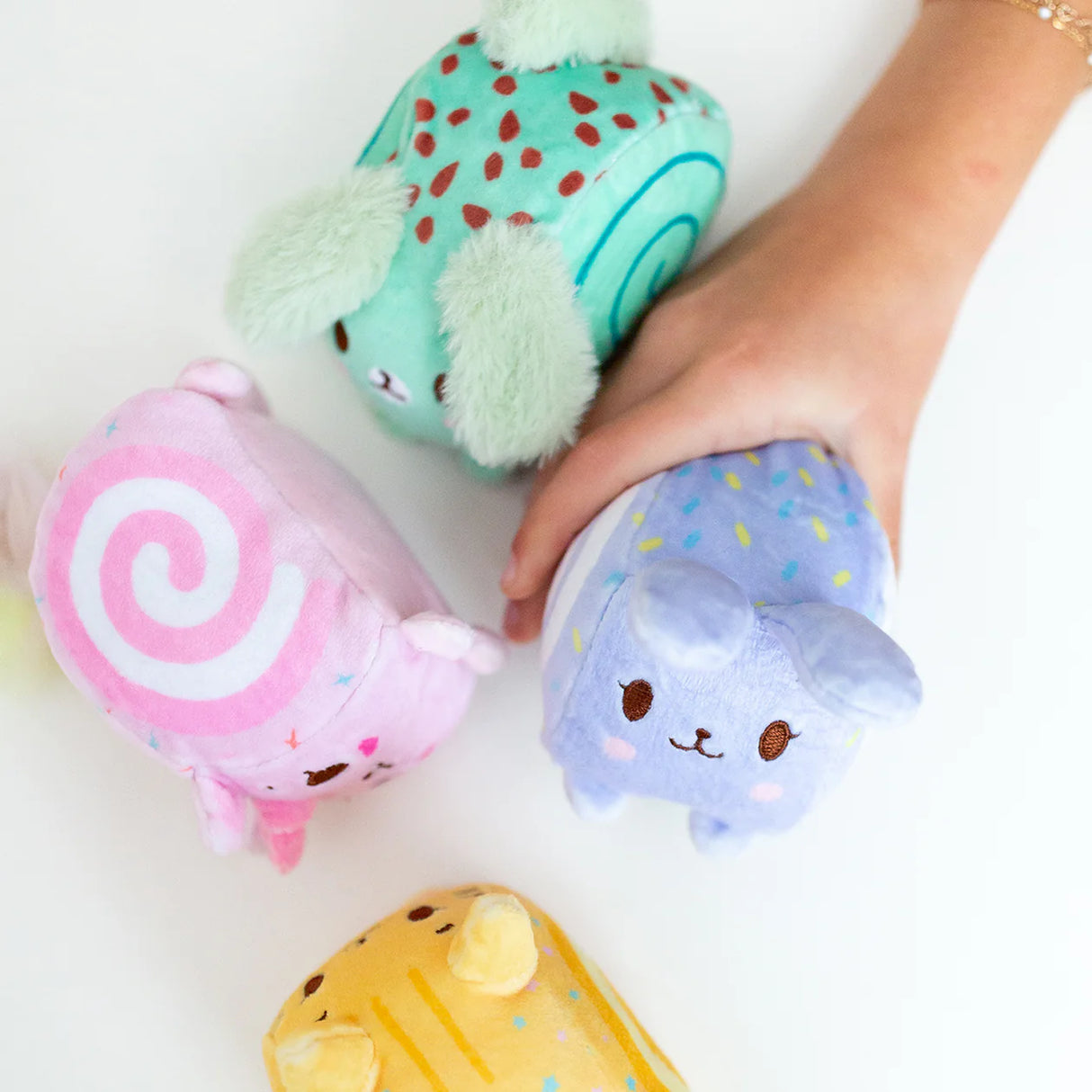 Squish Berries Sugar Squish scented squishy plush four characters held in hand