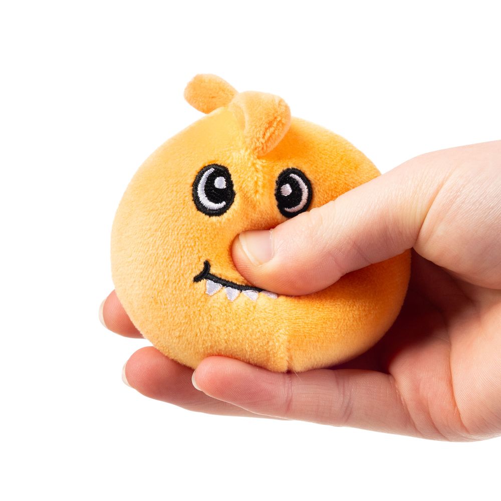 Hand squeezing orange squishy dinosaur plush sensory toy demonstrating soft sugar-filled texture