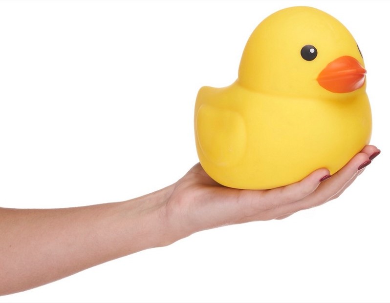 Large yellow squishy duck balanced on an open palm showing size