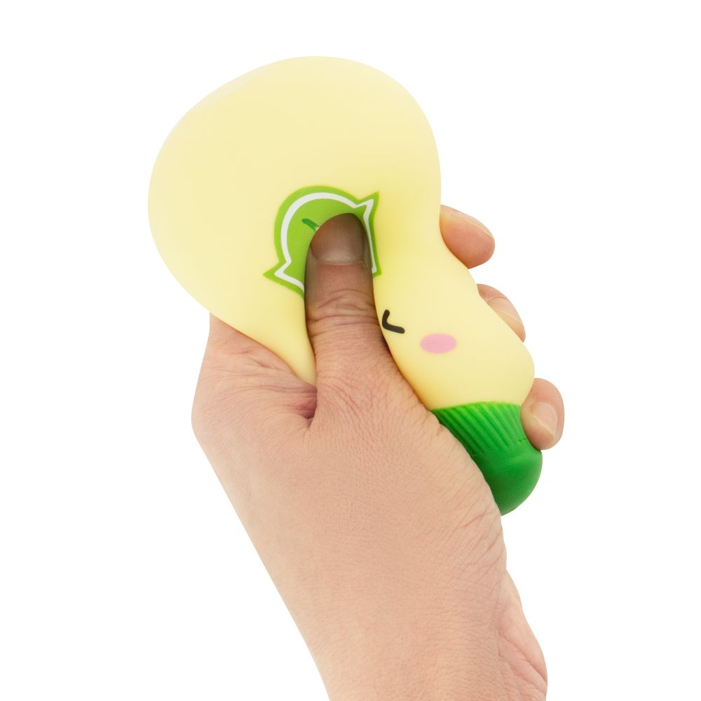 Hand squeezing a cream kawaii ranch dressing squishy bottle fidget toy, showing it deforming under pressure