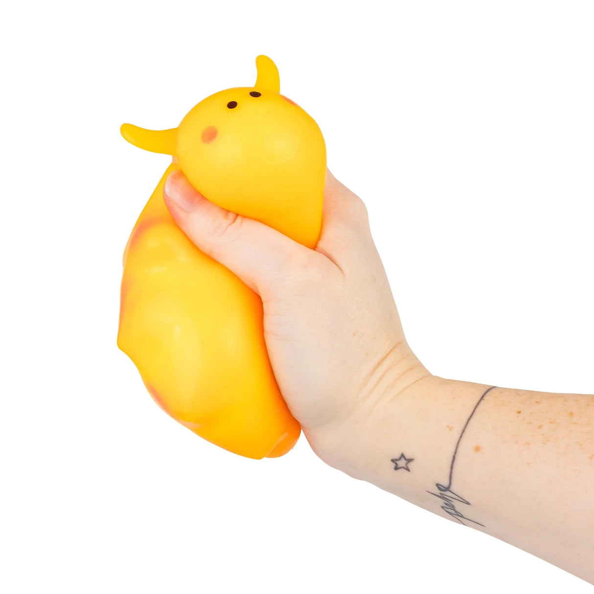 Hand squeezing an orange neon squishy sea sheep fidget toy, showing the soft squish
