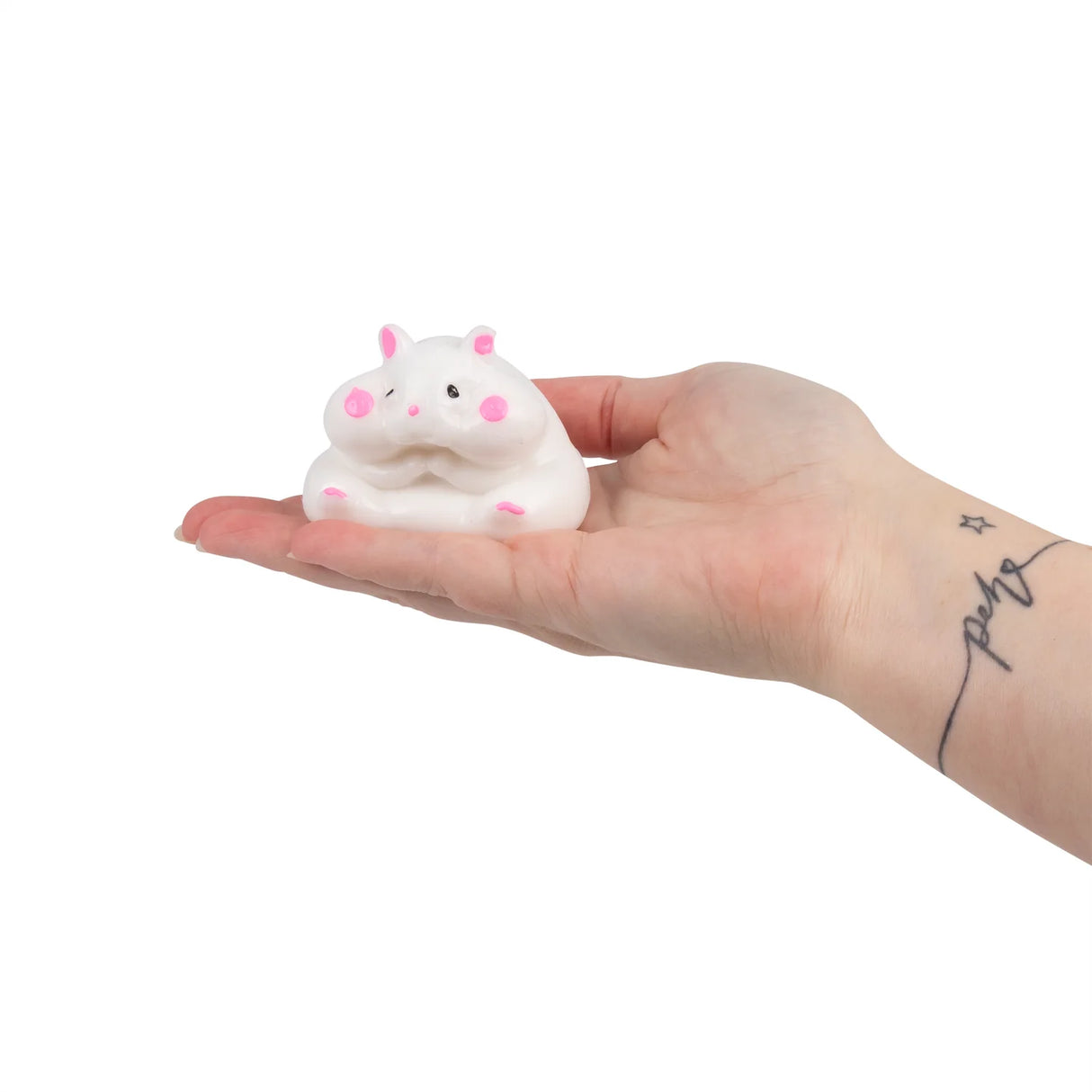 White kawaii Scrunchems Sticky Squishy Hamster resting in an open palm showing size