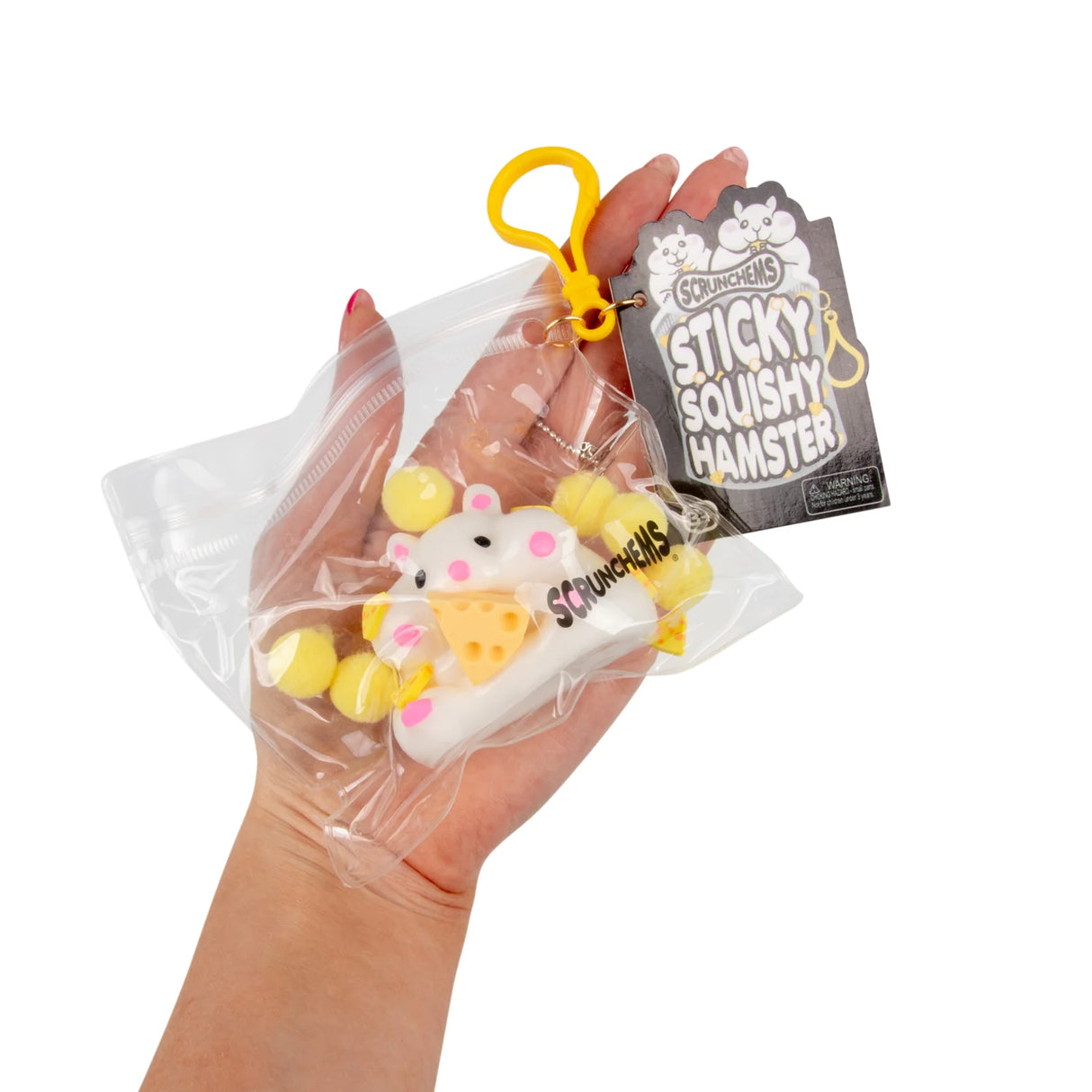Scrunchems Sticky Squishy Hamster in packaging held in a hand showing clip and tag