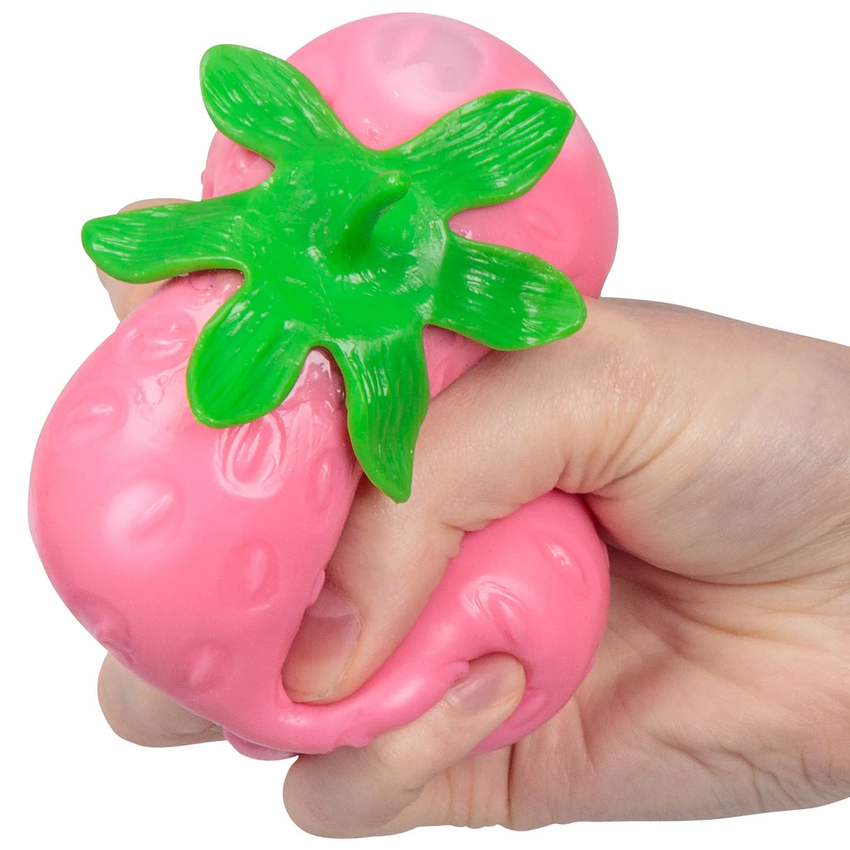 Hand squeezing a pink gel-filled strawberry stress toy, showing it deforming under pressure