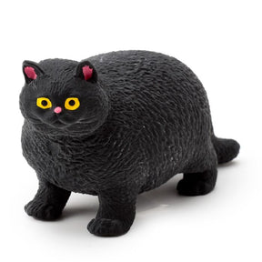 Black stretch fat cat stress toy with yellow eyes and pink ears on a white background