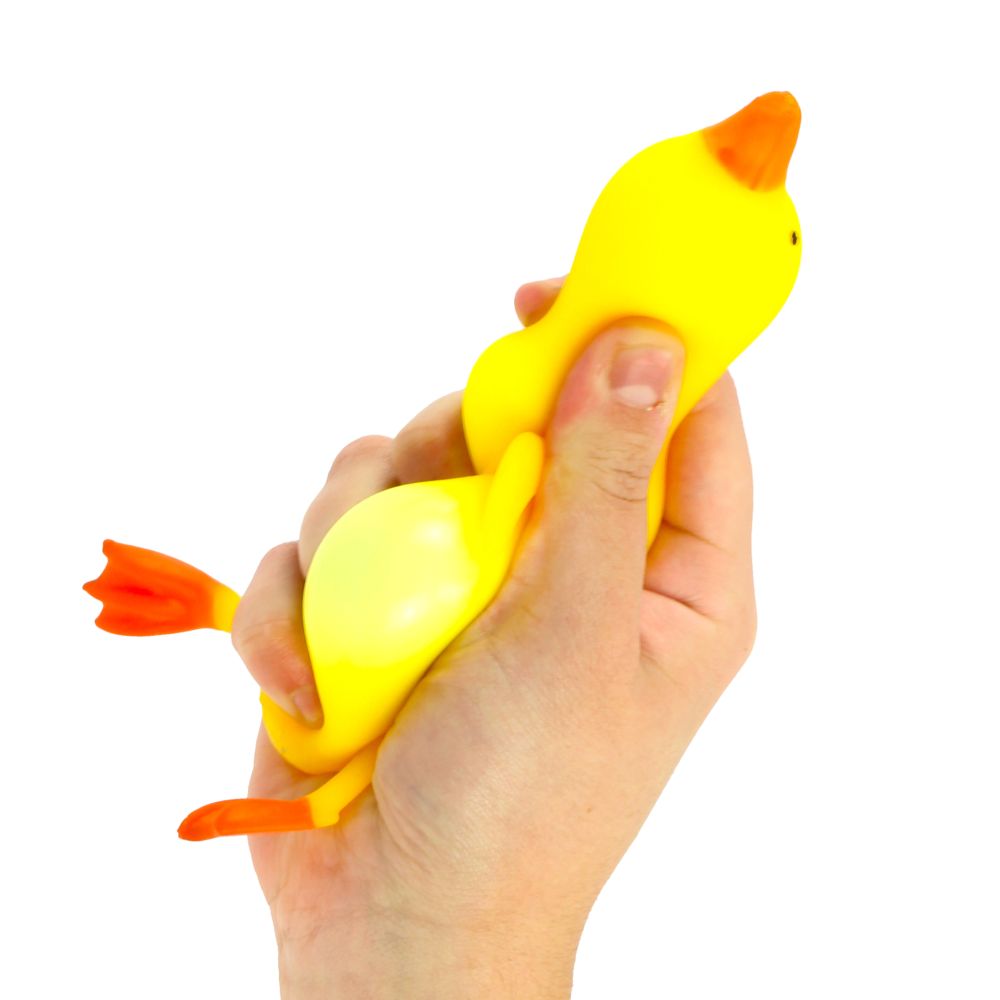 Hand squeezing a yellow stretchy rubber duck stress toy, showing the toy bulging and stretching
