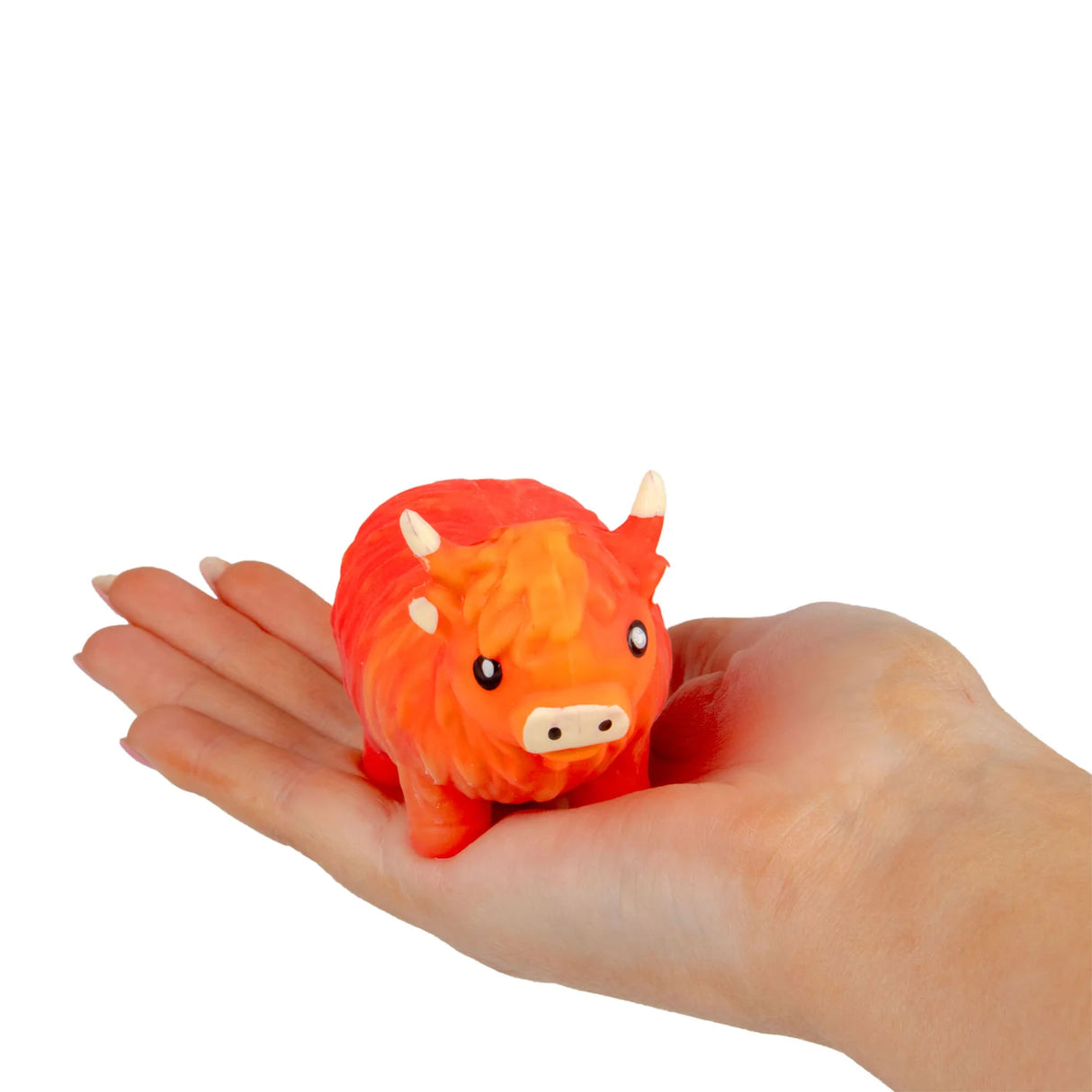 Orange and red stretchy sand highland cow sitting in an open palm to show compact size