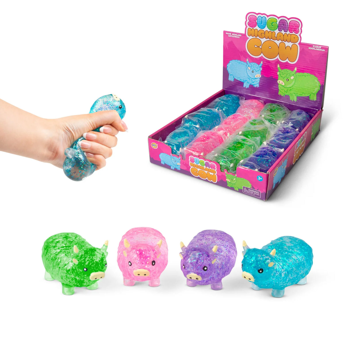 All four Sugar Highland Cow glitter squishies in green, pink, purple, and blue shown with branded display box