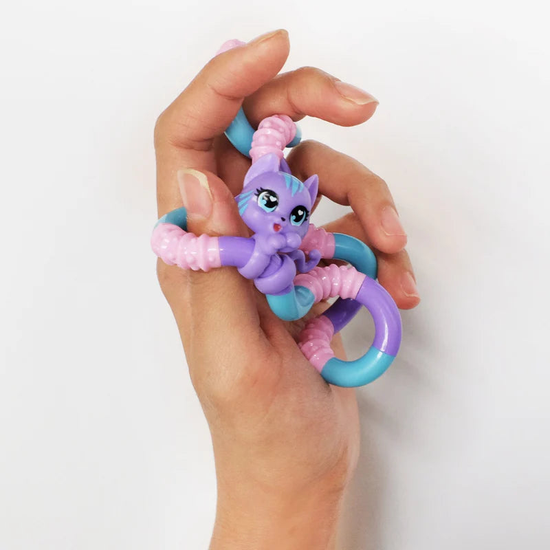 Hand holding a purple and blue cat Tangle Jr. Pet fidget toy wrapped around fingers