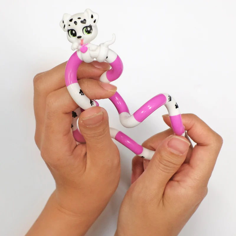 Two hands twisting a pink and white dalmatian Tangle Jr. Pet fidget toy