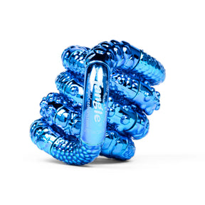 Blue textured metallic Tangle Jr. fidget toy coiled into its resting spiral shape showing ridged chrome surface