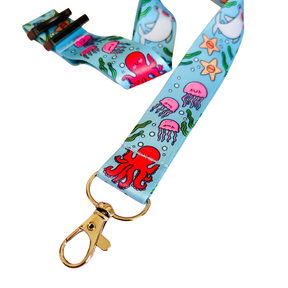 Lanyard with ocean-themed design featuring fish, jellyfish, and an octopus on a blue background.