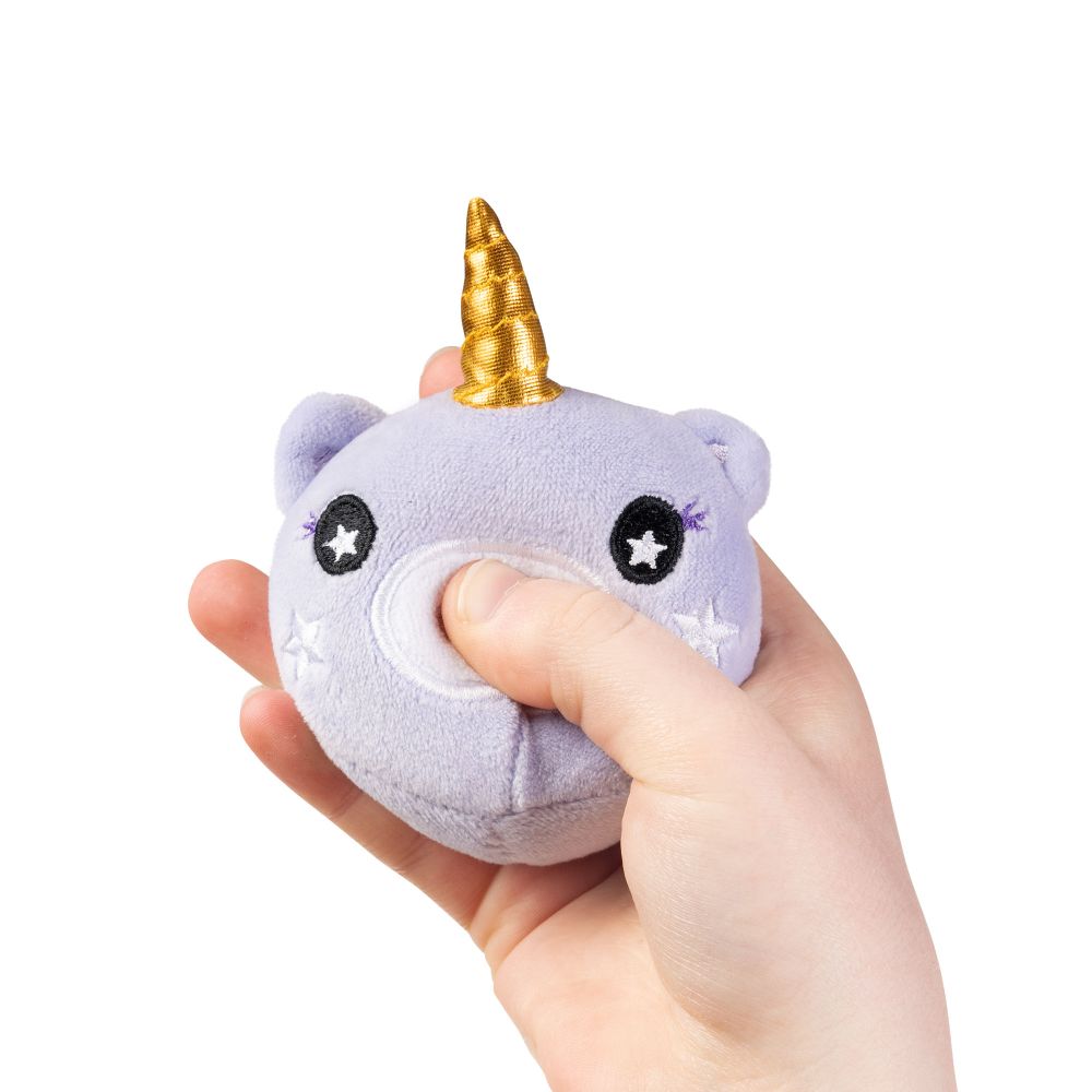 Hand squeezing a lilac unicorn plushie sensory toy showing the squishy sugar filling yielding under pressure