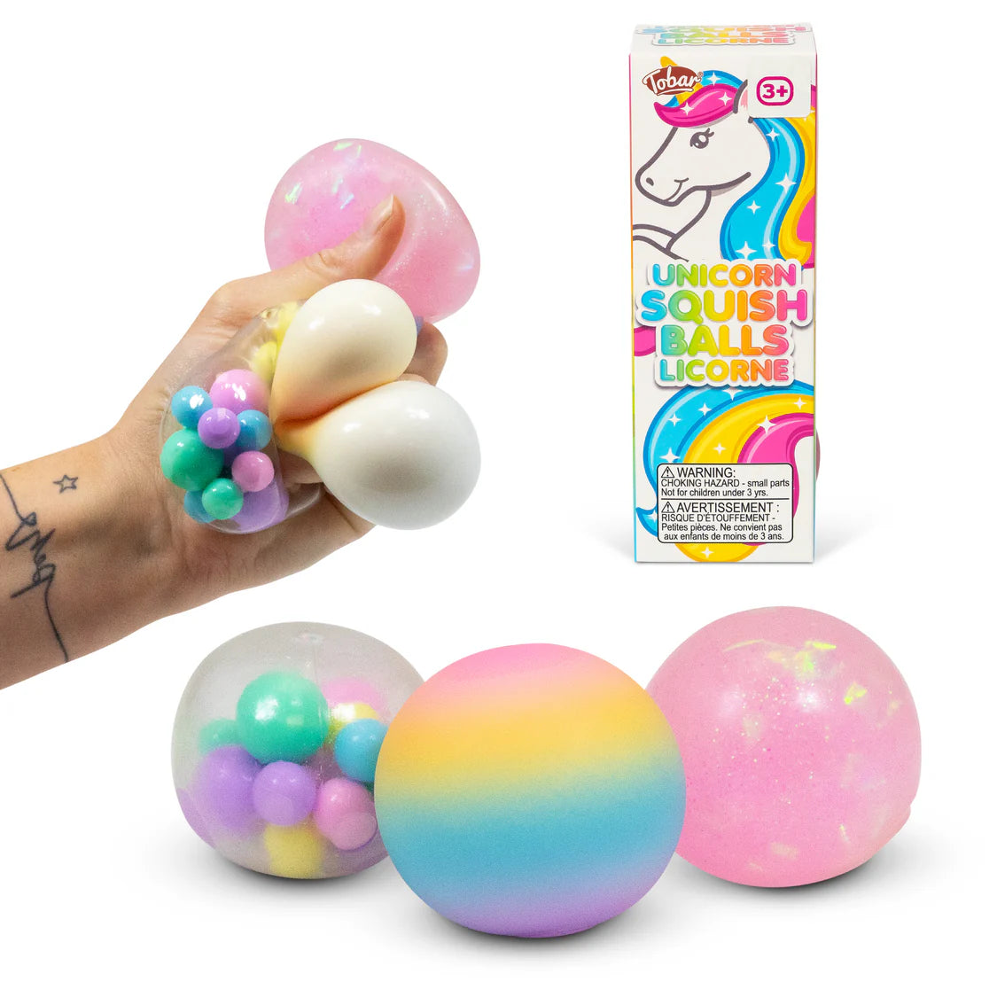 All three unicorn squish balls displayed together alongside their box — rainbow ombre, pink glitter, and clear bead-filled