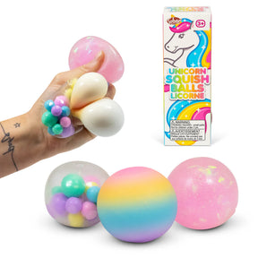 All three unicorn squish balls displayed together alongside their box — rainbow ombre, pink glitter, and clear bead-filled