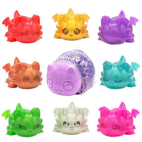 Eight colourful Aphmau MeeMeow squishy dragon figures arranged around their mystery capsule packaging