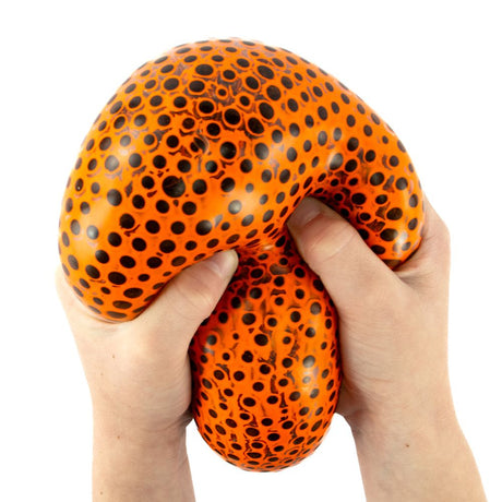 Two hands squeezing and stretching an orange Beadz Alive giant ball