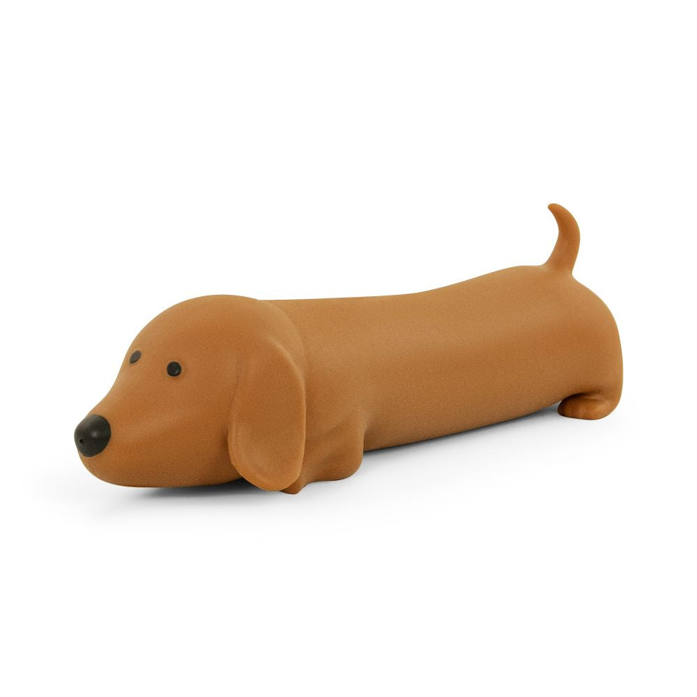 Hand holding Big Squij Dachshund squishy toy showing face and floppy ears detail