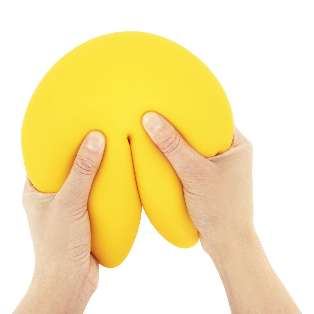 Yellow fortune cookie squishy toy squeezed in hands, jumbo slow-rise sensory fidget toy