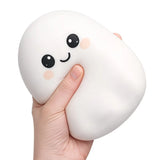 Ghost squishy toy squeezed in hand, soft slow-rise sensory fidget toy