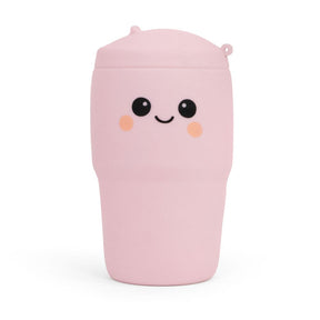 Pastel pink Big Squij Tumbler squishy toy with a smiling face, standing alone