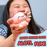 A woman holding a pink squishy toy with a cute cartoon face, with a text overlay that reads 'MAKE OFFICE DAYS AOTL FUN!'.