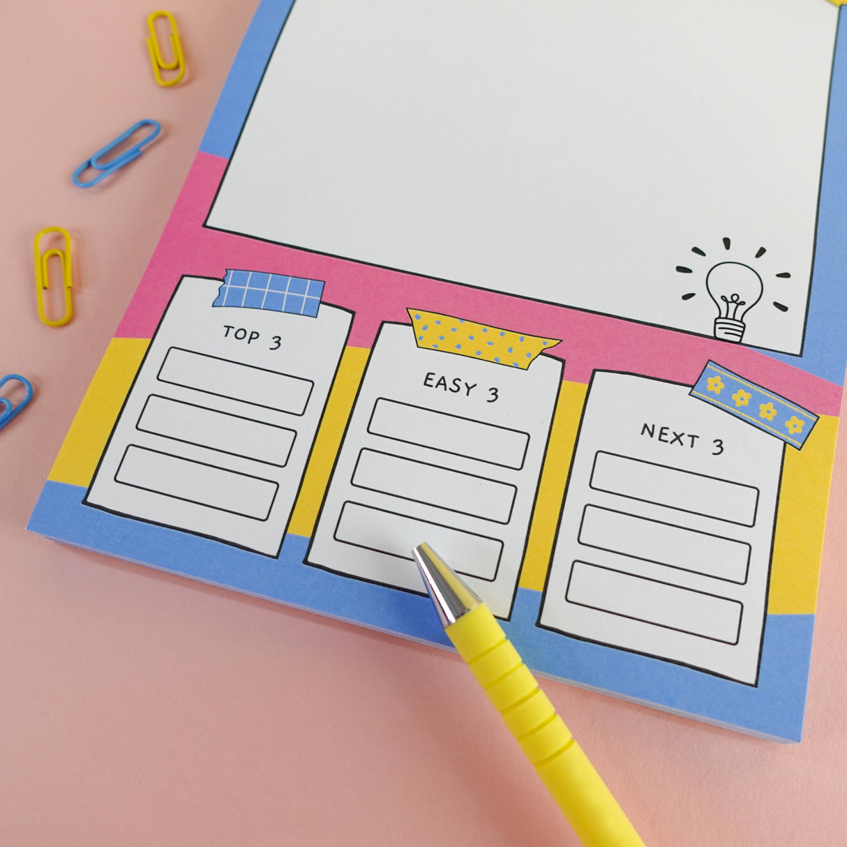 Brain dump notepad task columns with colourful paperclip styling detail