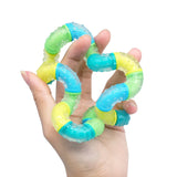 Colorful hand gripper being held in a hand on a white background