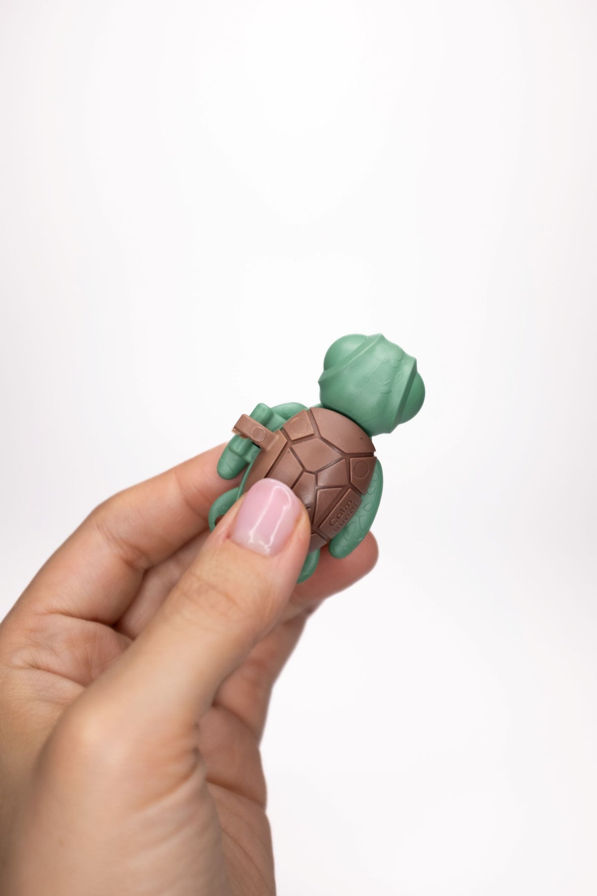 Forest green Calm Buddi Turtle fidget toy held in hand, front view