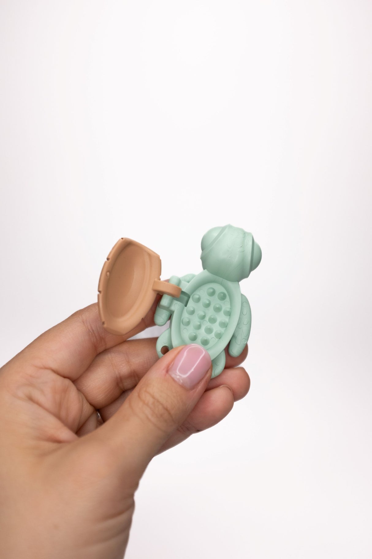 Mint Calm Buddi Turtle held open showing spiky inner cavity, sensory fidget toy