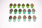 Calm Buddi Turtle fidget toys laid out in rows, green and teal Nature colourway