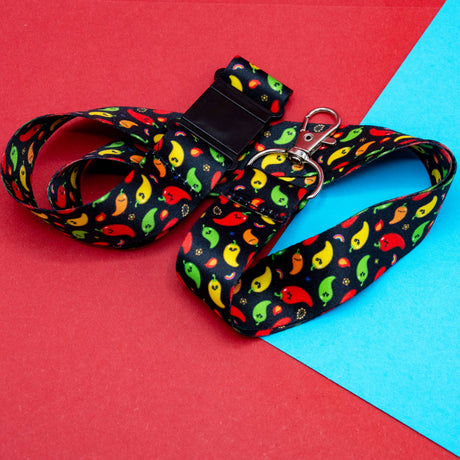 black chili pattern lanyard with colourful peppers and silver clasp on red blue background