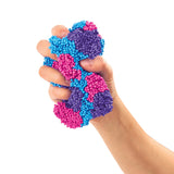 Hand squeezing multicoloured blue pink and purple Cra-Z-Compounds foam bead sensory toy