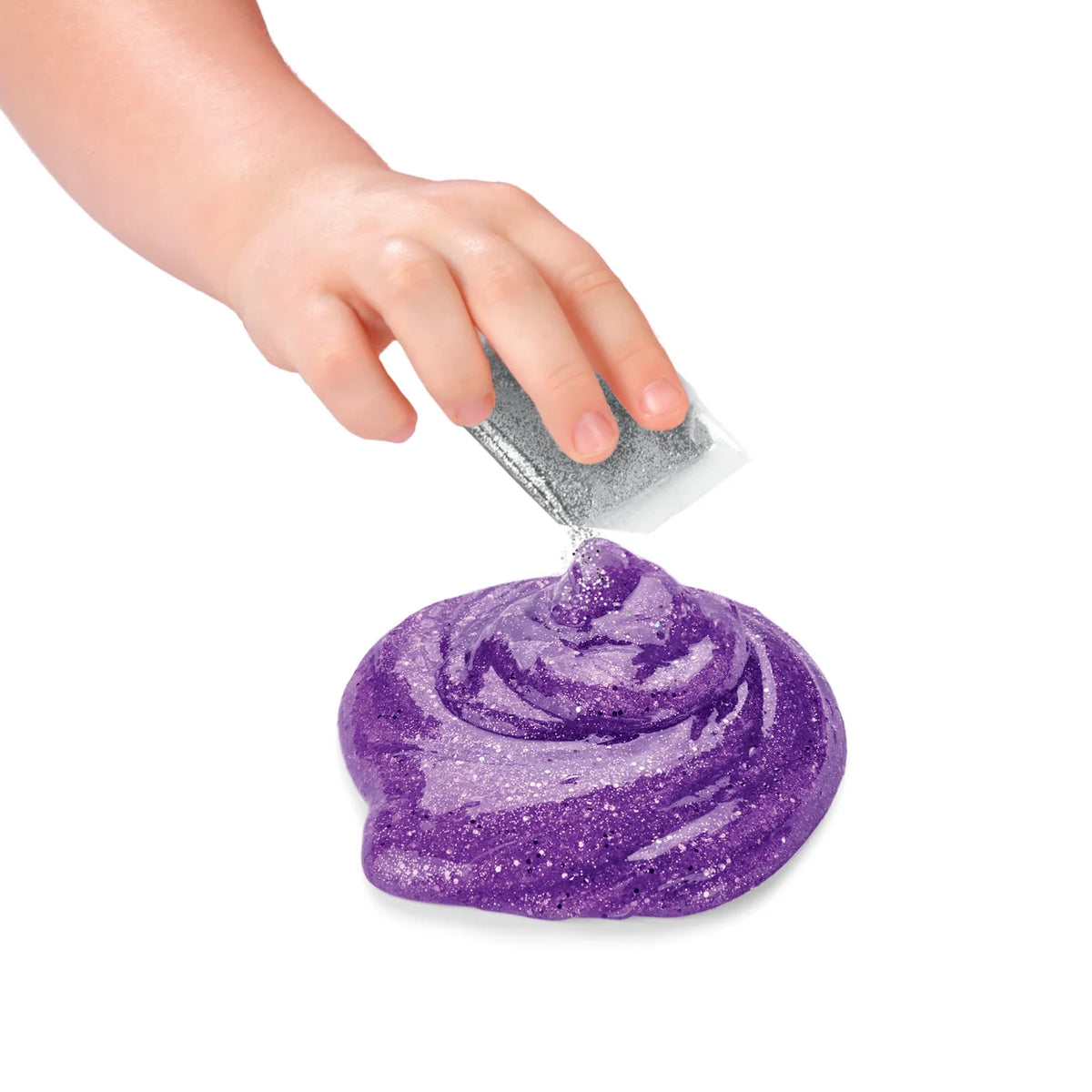 Hand sprinkling silver glitter onto purple glittery Cra-Z-Compounds sensory slime swirl