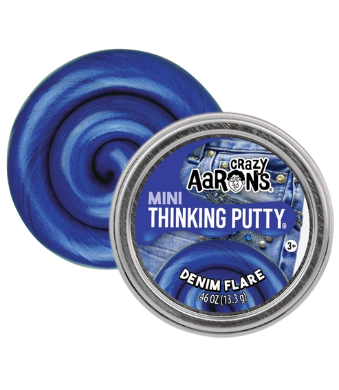 A round tin of Crazy Aaron's Mini Thinking Putty in the shade Denim Flare, shown next to a swirl of the blue putty on a white background.