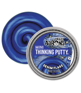 A round tin of Crazy Aaron's Mini Thinking Putty in the shade Denim Flare, shown next to a swirl of the blue putty on a white background.