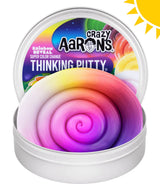 Crazy Aaron's Rainbow Reveal Super Colour Change Thinking Putty open tin showing vibrant rainbow swirl putty with sun and UV-themed lid artwork