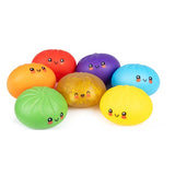 Seven Crazy Fun Mystery Squishy Dumplings in red, orange, yellow, green, blue, purple and rare gold with smiling faces