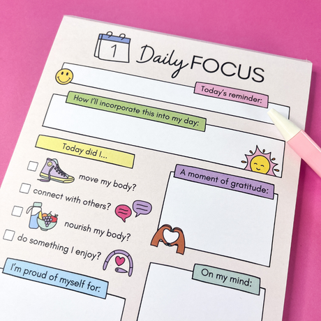 Close-up of Daily Focus notepad top half, colourful pastel daily planner