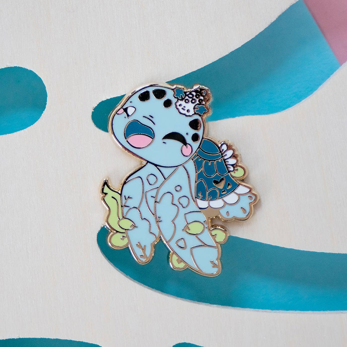 Evy Benita Leatherback Sea Turtle enamel pin on teal ribbon background