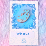 Evy Benita Lullaby Sky Whale enamel pin on floral backing card, pink background