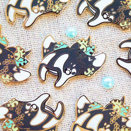Evy Benita Oceanic Manta Ray enamel pins displayed on burlap, multiple pins